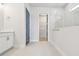 Bright bathroom featuring a marble shower, double vanity, and walk-in closet at 1583 Running Tide Pl, Sarasota, FL 34240