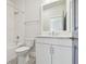 Bathroom with tub and shower, white vanity and patterned tile flooring at 1583 Running Tide Pl, Sarasota, FL 34240