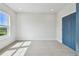Bedroom with carpet flooring, a large window, and blue door at 1583 Running Tide Pl, Sarasota, FL 34240