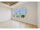 Light-filled bedroom with wood floors, unique ceiling, and lake views at 1583 Running Tide Pl, Sarasota, FL 34240