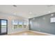 Bedroom featuring a lake view, blue accent wall, and wood floors at 1583 Running Tide Pl, Sarasota, FL 34240