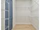 Walk-in closet featuring wire shelving and light wood floors at 1583 Running Tide Pl, Sarasota, FL 34240
