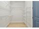 Walk-in closet with white wire shelving and wood floor at 1583 Running Tide Pl, Sarasota, FL 34240