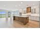 Bright, open kitchen with an island, modern appliances, and ample cabinet space at 1583 Running Tide Pl, Sarasota, FL 34240