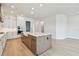 Spacious kitchen featuring a large island with a farmhouse sink and modern appliances at 1583 Running Tide Pl, Sarasota, FL 34240