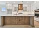 Bright kitchen featuring a large island, custom cabinets, and stainless steel appliances at 1583 Running Tide Pl, Sarasota, FL 34240