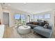 Inviting living room with hardwood floors, neutral furniture, and scenic backyard views at 1583 Running Tide Pl, Sarasota, FL 34240