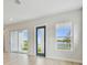 Bright living room with sliding doors and lake views at 1583 Running Tide Pl, Sarasota, FL 34240