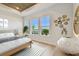 Serene primary bedroom features elegant decor, a wood-look ceiling, and picturesque lake views at 1583 Running Tide Pl, Sarasota, FL 34240