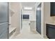 Mudroom with built-in bench, storage cabinets, and easy access to laundry room at 1583 Running Tide Pl, Sarasota, FL 34240