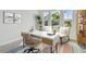 Well-lit home office features neutral tones, a modern desk, and bright natural light at 1583 Running Tide Pl, Sarasota, FL 34240