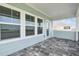 Covered patio features brick pavers, exterior lighting, and views of the backyard at 1583 Running Tide Pl, Sarasota, FL 34240