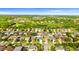 An aerial view shows a single-Gathering home near a tranquil pond in a residential neighborhood at 1631 Shady Oaks Dr, Oldsmar, FL 34677