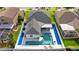 Bird's-eye view displays a backyard oasis with a sparkling pool, deck chairs, and well kept landscaping at 1631 Shady Oaks Dr, Oldsmar, FL 34677