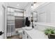 Modern bathroom with white vanity, an undermount sink, and a framed mirror with great natural light at 1631 Shady Oaks Dr, Oldsmar, FL 34677