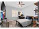 Cozy bedroom featuring a wood desk and bed with wood laminate flooring and natural light from a window at 1631 Shady Oaks Dr, Oldsmar, FL 34677