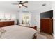 Bedroom with access to backyard through sliding glass doors and wood furnishings at 1631 Shady Oaks Dr, Oldsmar, FL 34677
