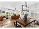 Bright dining room with an adjacent office space, wood floors, and a modern chandelier at 1631 Shady Oaks Dr, Oldsmar, FL 34677