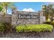 Stone entrance sign for Eastlake Oaks community, complemented by manicured landscaping at 1631 Shady Oaks Dr, Oldsmar, FL 34677