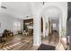 Inviting entryway with arched doorways, wood accent wall, and modern lighting at 1631 Shady Oaks Dr, Oldsmar, FL 34677