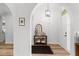 Inviting home foyer featuring arched doorways, wood floors, and stylish decor at 1631 Shady Oaks Dr, Oldsmar, FL 34677