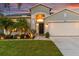 Charming single-story home boasting a well-manicured lawn, tropical landscaping, and attached two-car garage at 1631 Shady Oaks Dr, Oldsmar, FL 34677