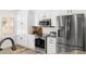 Bright kitchen featuring stainless steel appliances, white cabinetry, and modern finishes at 1631 Shady Oaks Dr, Oldsmar, FL 34677