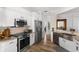 Beautiful kitchen featuring white cabinetry, stainless steel appliances, and a stylish backsplash at 1631 Shady Oaks Dr, Oldsmar, FL 34677