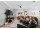 Comfortable living room with hardwood flooring, plush sofas, and an entertainment center at 1631 Shady Oaks Dr, Oldsmar, FL 34677
