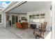Covered patio with tile flooring, wood furniture, a ceiling and great natural light from the windows at 1631 Shady Oaks Dr, Oldsmar, FL 34677