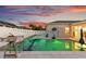 Beautiful backyard pool with deck chairs, and a unique lighting and an adjacent privacy fence at 1631 Shady Oaks Dr, Oldsmar, FL 34677