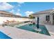 Wide shot of a backyard pool with lounge chairs and basketball hoop under a blue sky and cloudscape at 1631 Shady Oaks Dr, Oldsmar, FL 34677