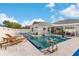 Inviting backyard pool with lounge chairs, a basketball hoop, and a covered patio area at 1631 Shady Oaks Dr, Oldsmar, FL 34677