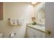 Bright bathroom with a white vanity, decorative towels, and well-lit mirror at 1712 Hammock Pine Blvd # 1712, Clearwater, FL 33761
