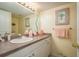 Well-maintained bathroom features a large vanity, mirror, and decorative accents for a comfortable space at 1712 Hammock Pine Blvd # 1712, Clearwater, FL 33761