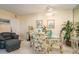 Cozy dining area features a glass table, floral chairs, and beach-themed decor at 1712 Hammock Pine Blvd # 1712, Clearwater, FL 33761