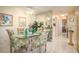 Dining room area with mirrored wall, glass table, and coastal decor at 1712 Hammock Pine Blvd # 1712, Clearwater, FL 33761