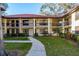 Inviting two-story condo complex with well-maintained landscaping and a tile roof at 1712 Hammock Pine Blvd # 1712, Clearwater, FL 33761