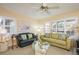 Bright living room with couches, large windows, and beachy decor at 1712 Hammock Pine Blvd # 1712, Clearwater, FL 33761