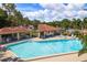 View of the large pool and community amenities under a sunny sky at 1712 Hammock Pine Blvd # 1712, Clearwater, FL 33761
