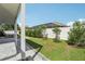 Landscaped backyard featuring lush green lawn, privacy fence and tasteful plantings at 1802 Regal Mist Loop, Trinity, FL 34655