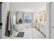 Elegant bathroom with a freestanding tub, white cabinets, and a glass-enclosed shower at 1802 Regal Mist Loop, Trinity, FL 34655