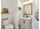 Cozy half bathroom with stylish vanity, neutral colors, and modern fixtures at 1802 Regal Mist Loop, Trinity, FL 34655