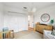 Bedroom with crib, dresser, and modern light fixture at 1802 Regal Mist Loop, Trinity, FL 34655