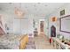 Charming bedroom featuring whimsical decor, wood floors, and ample natural light at 1802 Regal Mist Loop, Trinity, FL 34655