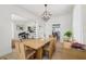 Bright dining room with chandelier, connecting to the living room and kitchen at 1802 Regal Mist Loop, Trinity, FL 34655
