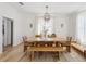 Sunlit dining room with modern chandelier, large dining table, and stylish decor at 1802 Regal Mist Loop, Trinity, FL 34655