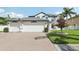 Charming two-story home with a three car garage, beautiful landscaping, and manicured lawn at 1802 Regal Mist Loop, Trinity, FL 34655