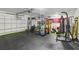 Spacious garage is well equipped with fitness equipment and a padded floor at 1802 Regal Mist Loop, Trinity, FL 34655