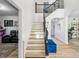 Bright entrance boasts hardwood floors, a modern staircase, and stylish decor at 1802 Regal Mist Loop, Trinity, FL 34655